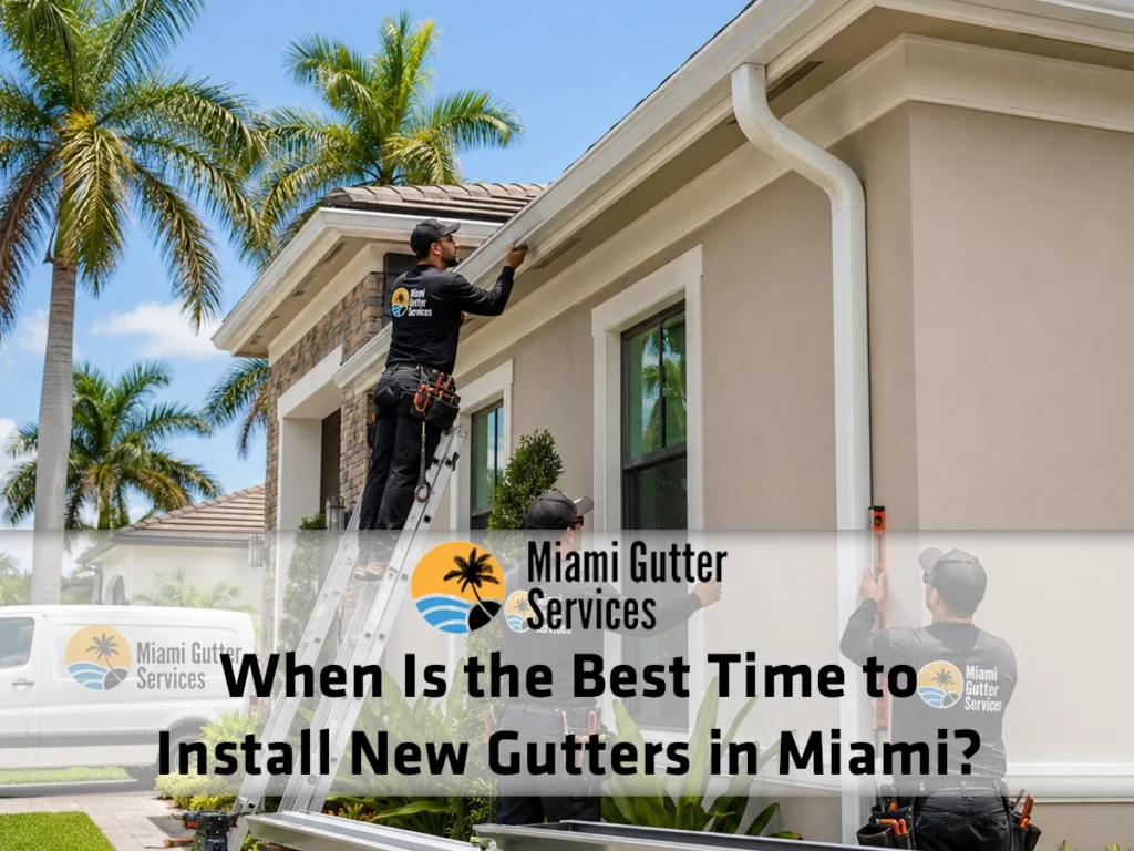 Professional gutter installers fitting new seamless gutters and downspouts on a Miami home during dry weather before the rainy season